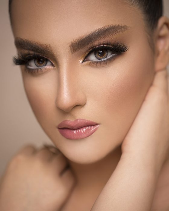 Woman in elegant suntanned makeup promoting skin care